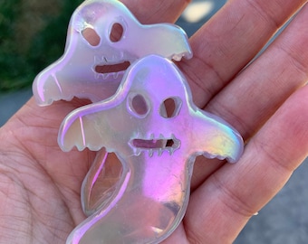 1 aura coated fluorite ghost carving ! Spooky season. Halloween time ! Crystal collection