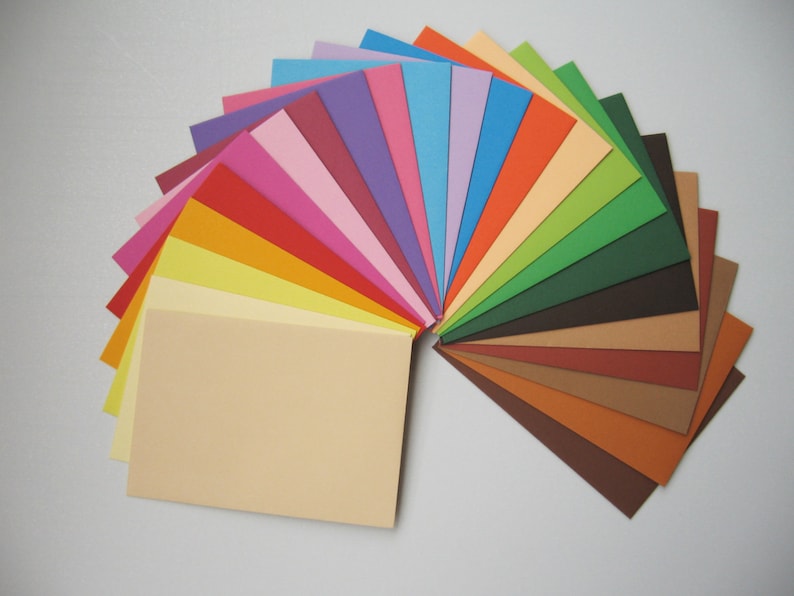 May include: A fan-shaped arrangement of 20 different coloured cardstock paper sheets. The colours range from light blue to dark brown.