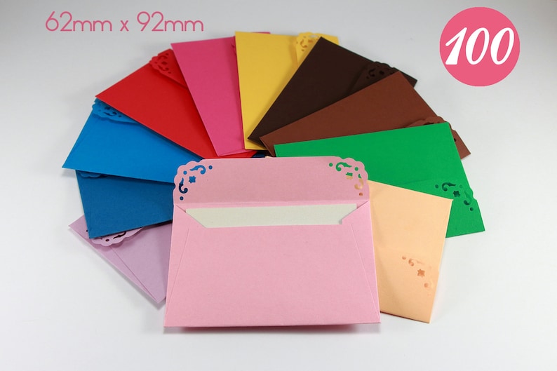 May include: A set of 100 envelopes in various colors, each measuring 62mm x 92mm. The envelopes have a decorative, scalloped edge and are perfect for adding a touch of elegance to your correspondence.