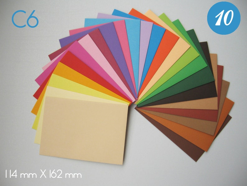 May include: A fan of 10 different coloured cardstock paper sheets in C6 size, measuring 114 mm x 162 mm. The colours are: light blue, purple, pink, red, orange, yellow, light yellow, green, dark green, brown, dark brown, light brown, orange, peach, light orange, light green, dark blue, light blue, and white.