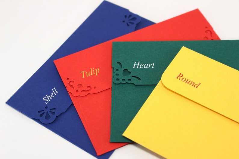 May include: Four different colored envelopes with decorative cutouts. The envelopes are blue, red, green, and yellow. The cutouts are shaped like a shell, tulip, heart, and circle. The envelopes are labeled with the names of the shapes.