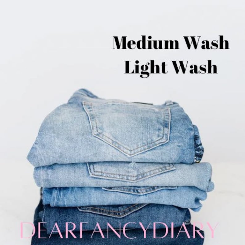 May include: A stack of blue denim jeans, with the top pair being a medium wash and the bottom pair being a light wash. The text "DEARFANCYDIARY" is visible at the bottom of the image.