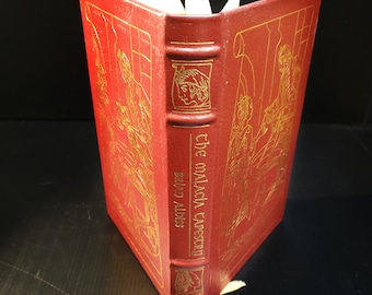 May include: A red leather-bound book with gold lettering on the spine. The title is "The Malacia Tapestry" by Brian Aldiss.
