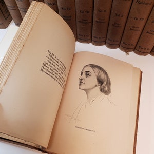 May include: An open book with a poem by Christina Rossetti. The book is titled "Journeys" and is part of a series of books by Elbert Hubbard. The book is open to a page with a black and white illustration of a woman's face.