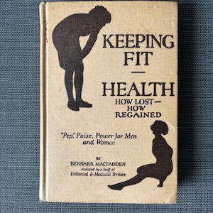 May include: A vintage book titled "KEEPING FIT HEALTH" with black silhouettes of people on the cover. The book's subtitle reads "HOW LOST - HOW REGAINED." The author is Bernarr Macfadden.