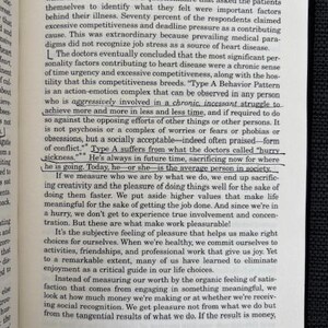 May include: Open book with text on a white page. The text is from a book chapter titled "Doing: An Addiction to Effortful Living." The page number 33 is visible. The book is on a dark gray surface.