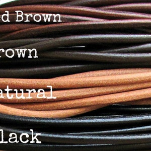 May include: Close-up of four different colors of leather cord: red brown, brown, natural, and black.