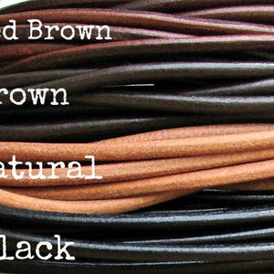 May include: Close-up of four different colors of leather cord: red brown, brown, natural, and black.