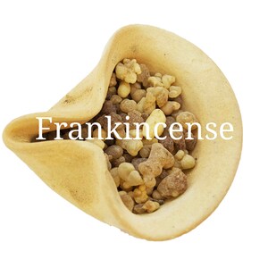 May include: A small, light brown ceramic bowl filled with frankincense resin. The resin is a mix of light brown, dark brown, and yellow pieces.