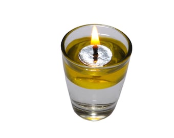 May include: A clear glass candle holder with a yellow liquid and a silver wick. The candle is lit and the flame is visible.