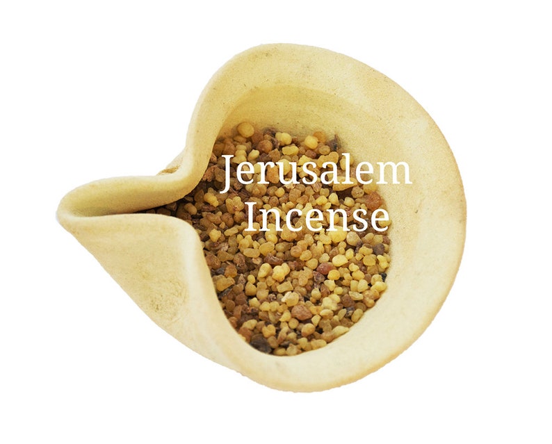 May include: A small ceramic bowl filled with brown and yellow Jerusalem incense. The bowl is light beige and has a unique shape.
