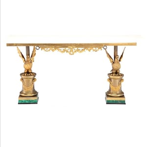 May include: A long, rectangular, white marble table with a gold metal frame and two eagle-shaped legs. The legs are on square bases with green malachite inlays.