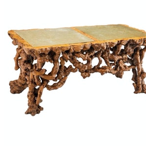 May include: A coffee table with a unique, natural wood base and a green stone top. The base is made of twisted branches and roots, giving it a rustic and organic look.