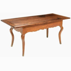 May include: A wooden table with a rectangular top and four legs. The legs are curved and have a decorative design. The table is made of a dark wood and has a natural finish.