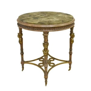 May include: A round antique side table with a green marble top. The table has ornate, carved wooden legs with gold accents and a decorative base. The table is approximately 24 inches in diameter and 28 inches tall.