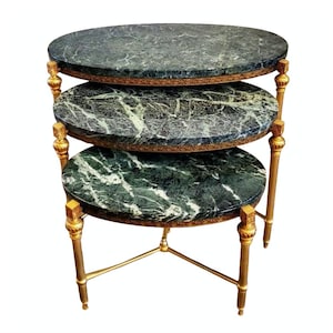 May include: A set of three nesting tables with oval green marble tops and gold-painted metal legs.