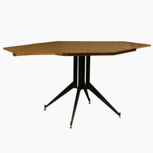 May include: A hexagonal wooden table with a black metal base and four legs. The table has a leaf that can be extended to increase its size.