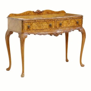 May include: A vintage walnut wood console table with two drawers and carved legs. The table has a rich brown color and a distressed finish.