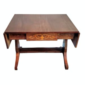 May include: A dark brown wooden drop leaf table with a single drawer featuring an inlaid floral design. The table has a simple, elegant design with turned legs.