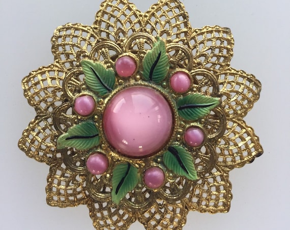 A striking Czechoslovakian filigree brooch set with pink glass and enamel