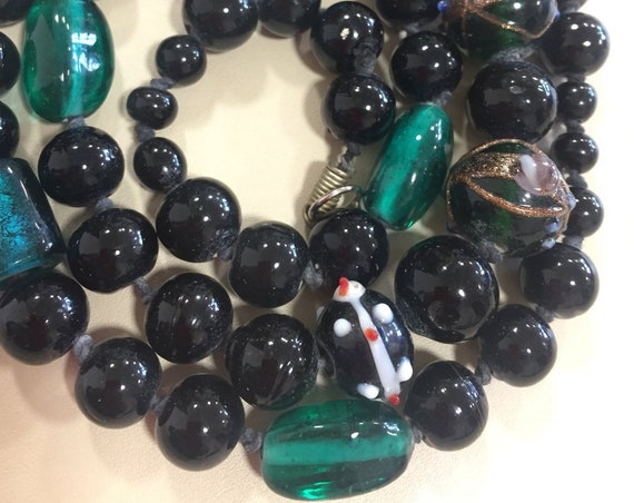 Beautiful vintage hand knotted glass beads, lamp-work and foil