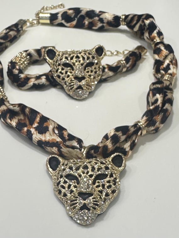 Fun set of oversized Rhinestone Leopard Head  Necklace and  Bracelet on print fabric