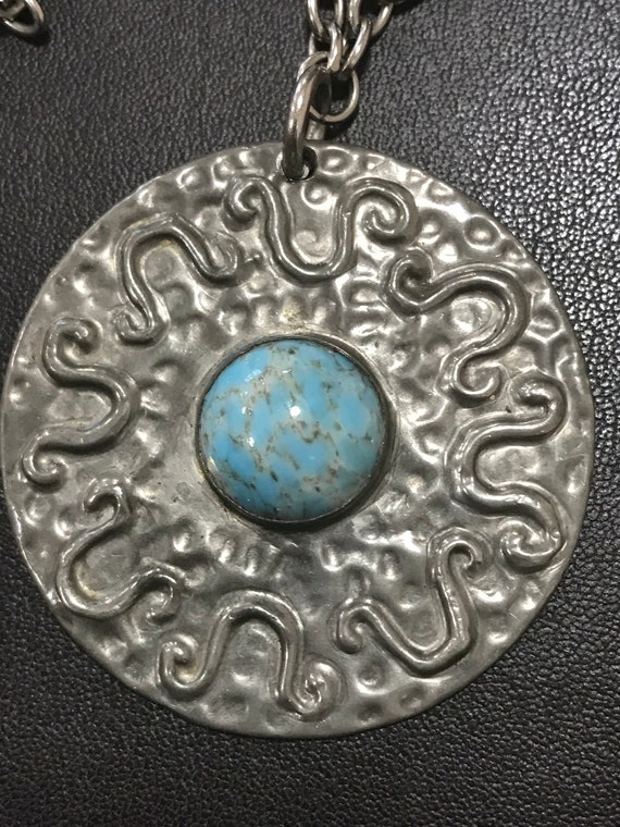 A vintage Ruskin style pewter pendant necklace with a Center turquoise glass cabochon