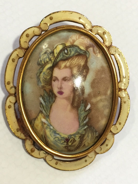 A striking vintage portrait brooch in enamel surround by Thomas L. Mott