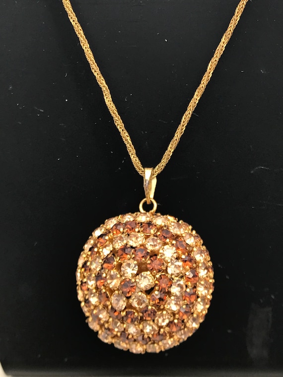 An Unusual 1960s 70s gold tones rhinestone ball pendant necklace and matching big clip on earrings