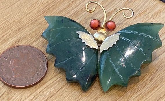 Vintage Butterfly brooch is made of a gold plated base metal and set with Jade and coral eyes.