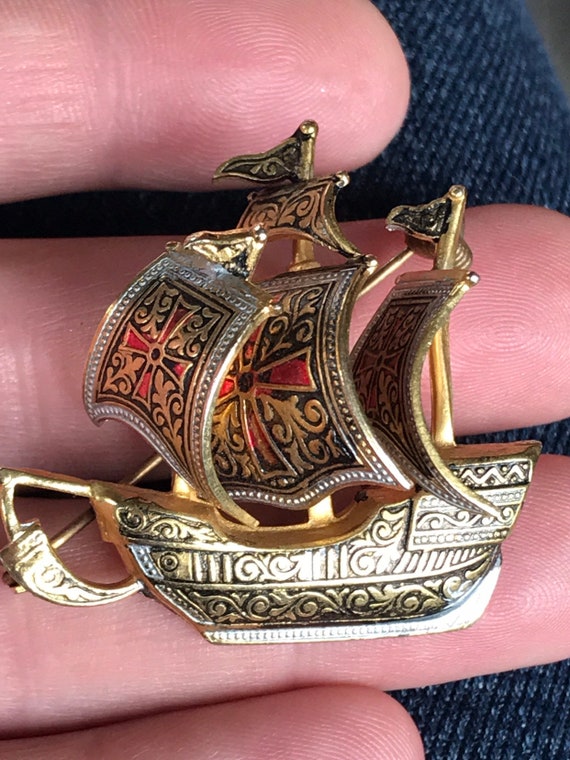 A striking 1960s Vintage Damascene black and gold ship brooch statement piece