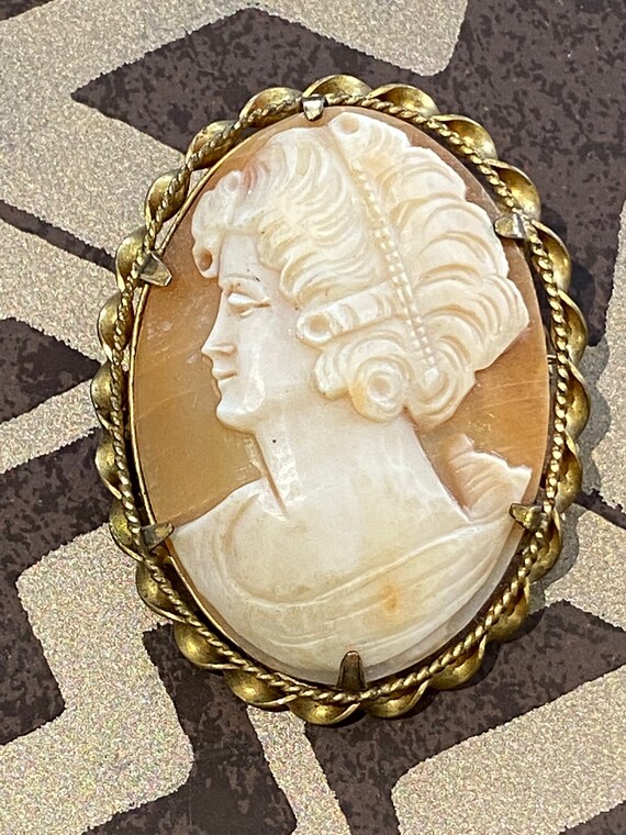 A hand carved vintage/ Antique real shell  cameo portrait brooch/pin/pendant set in an ornate gold toned frame