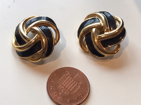 A beautiful pair of signed vintage clip-on earrings by makers Trifari TM logo