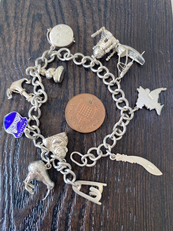 Lovely vintage solid silver charm bracelet with 10 mixed silver charms 30.5 in weight