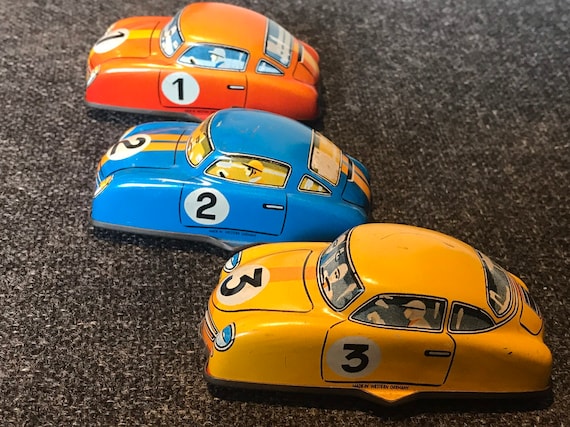 3 Original vintage tin lithograph wind up tin toy racing cars.