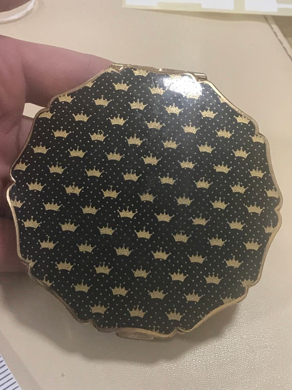 A vintage floral compact made by Stratton of England c1960s black with gold crowns