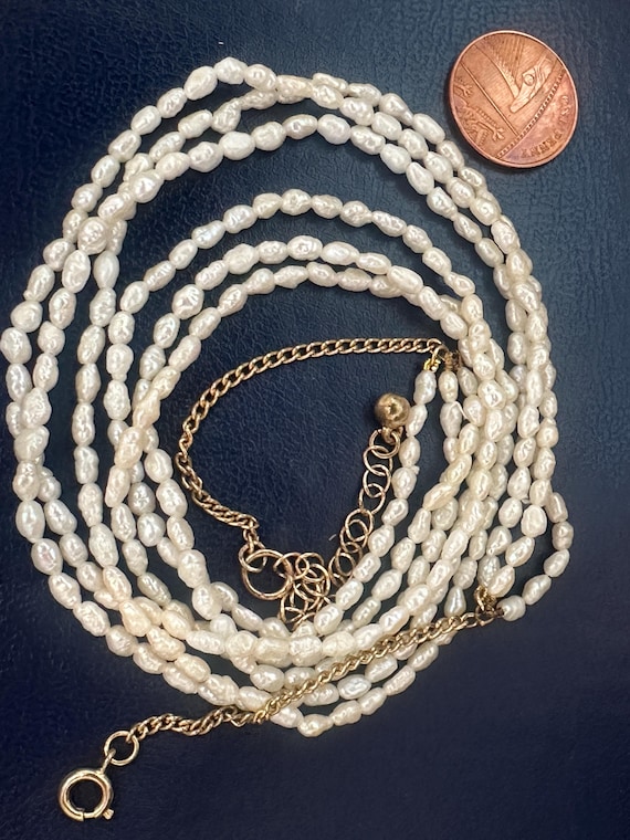 A vintage beaded 3 stranded  creamy white cultured baroque river pearl necklace long adjustable length