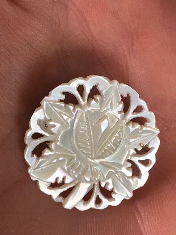 A beautiful vintage hand crafted carved mother of pearl brooch signed from Bethlehem