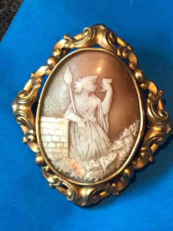 Large Victorian real shell cameo in elaborate pinchbeck framed brooch pin with safety chain