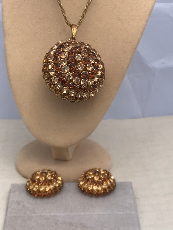 An Unusual 1960s 70s gold tones rhinestone ball pendant necklace and matching big clip on earrings