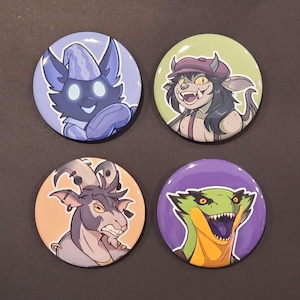 May include: Four round buttons with cartoon character illustrations. The buttons feature a blue creature, a goblin with a hat, a goat-like character, and a green lizard with sharp teeth. Each button has a different color background.