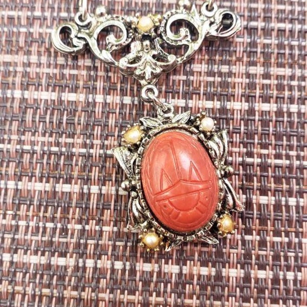 Vintage plastic coral Scarab and antique silver tone metal necklace by LJM