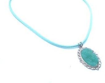 Necklace with silver colored pendant and turquoise cabochon attached to a turquoise faux leather cord. Handcrafted collar with cord, PerElle