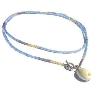 Necklace blue and beige glass beads. Handcrafted minimalist necklace, toggle clasp front side with cowrie shell pendant, seed beaded collar
