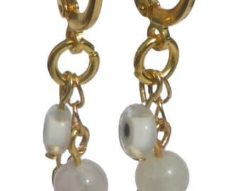 Gold-colored earrings with handmade pendant. Charm made of evil eye, charm semi-precious stone, Ibiza hoop earring, Per Elle jewelry, Europe