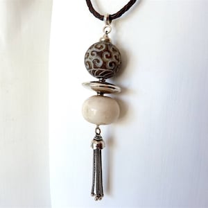 Jade and horn pendant on leather strap with silver tassel, engraved jade bead from Burma, Chinese horn bead, long necklace with pendant