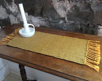 Hand-woven rectangular table's center (gold & black) . Weaving with fringes. Table setting, home decoration