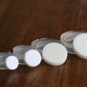 May include: Four white silicone moulds of different sizes for making round soap or resin crafts.