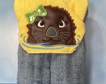 Hooded Towel with an embroidered character on it.