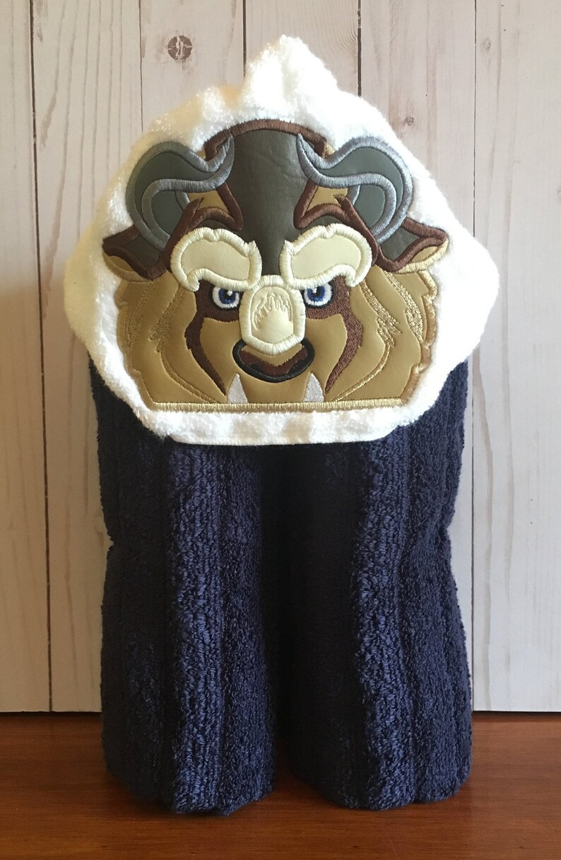 Hooded bath towel with an embroidered Beast on it.